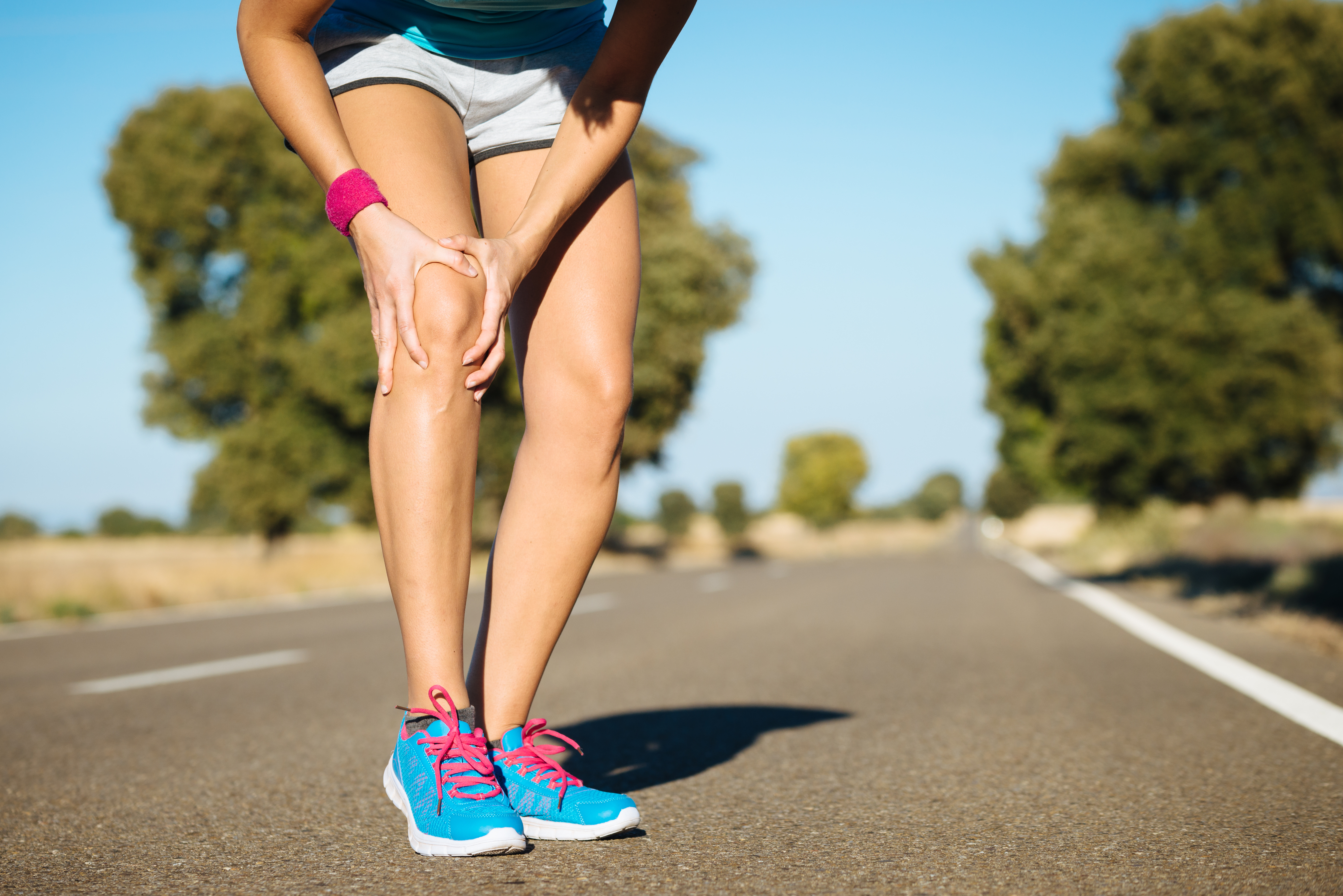 Runner holding injured knee