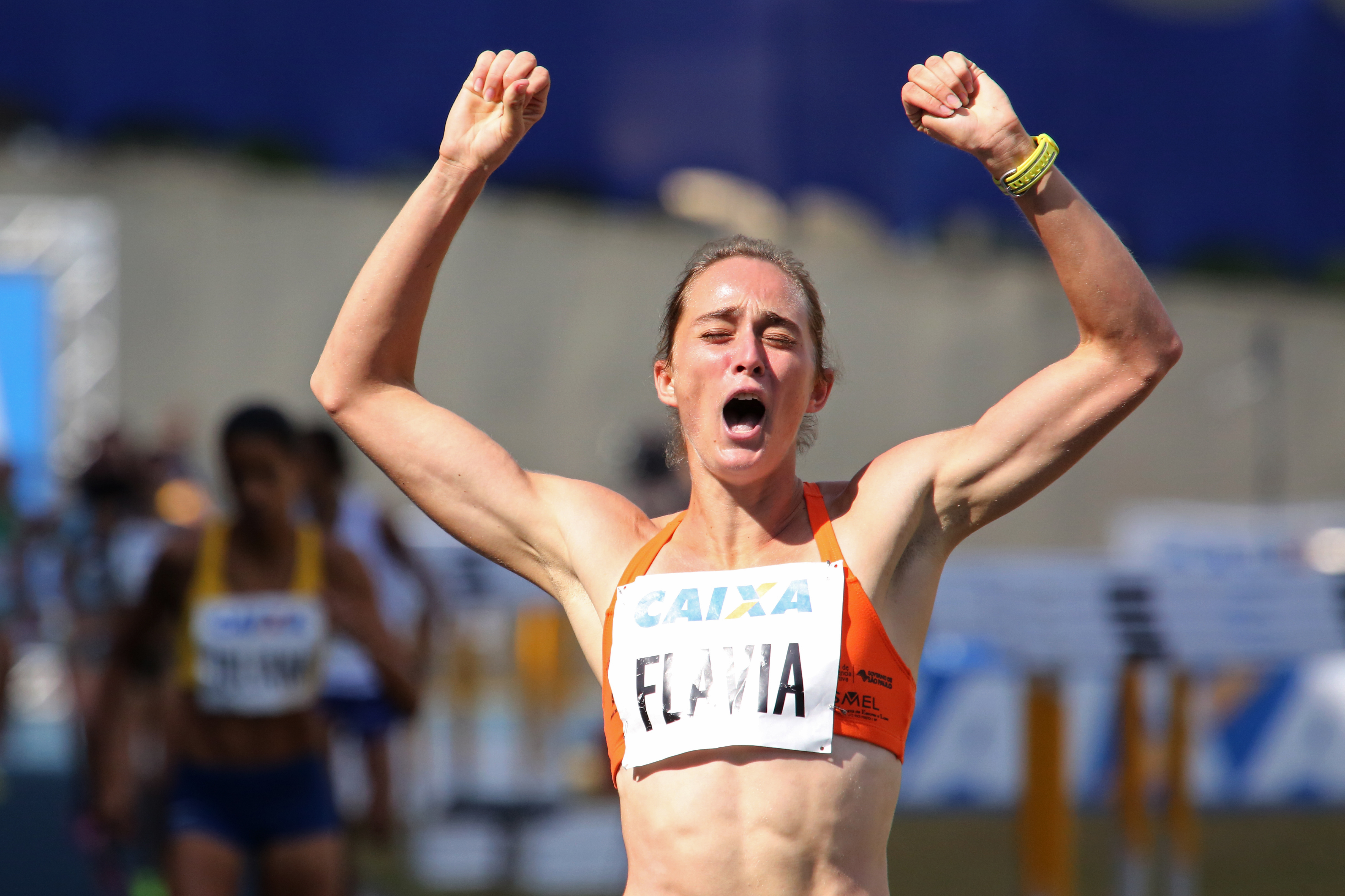 runner-celebrating-with-arms-in-air
